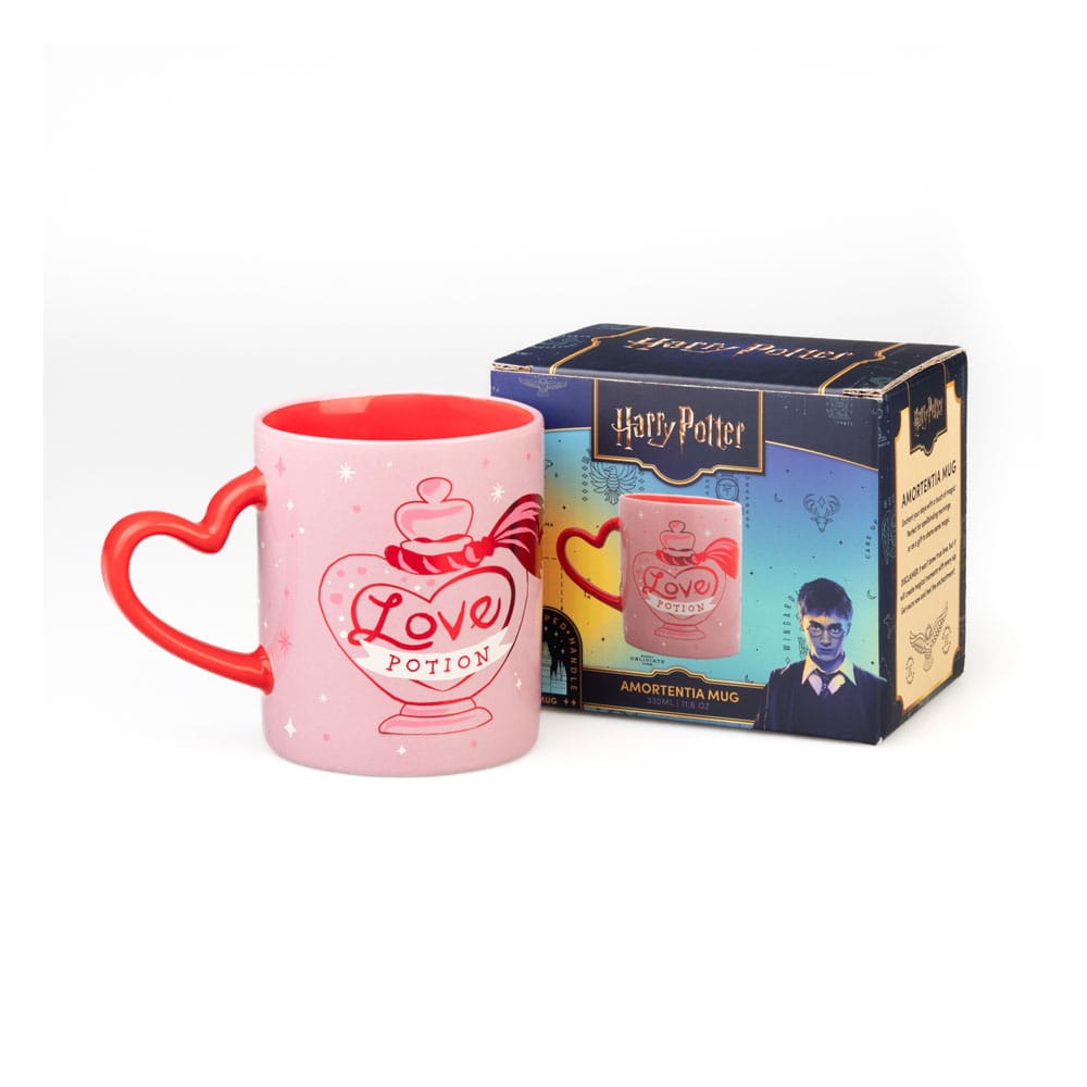 Roze keramische mok met rode binnenkant en rood hartvormig oor links, versierd met sterretjes en een liefdesdrankflesje met de tekst ‘Love Potion’. De mok staat voor een Harry Potter-doos op een witte achtergrond.
