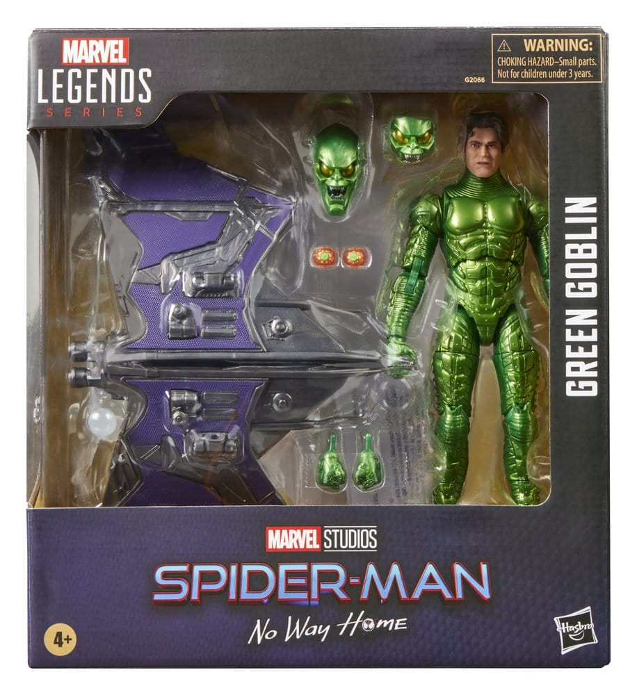 Kunststof Green Goblin-actiefiguur in glanzend groen harnas, rechtop in een zwart-paarse doos met kijkvenster. Naast hem zitten een paars-zilveren zweefvliegtuig, twee groene maskers en extra handen, tegen een witte achtergrond.